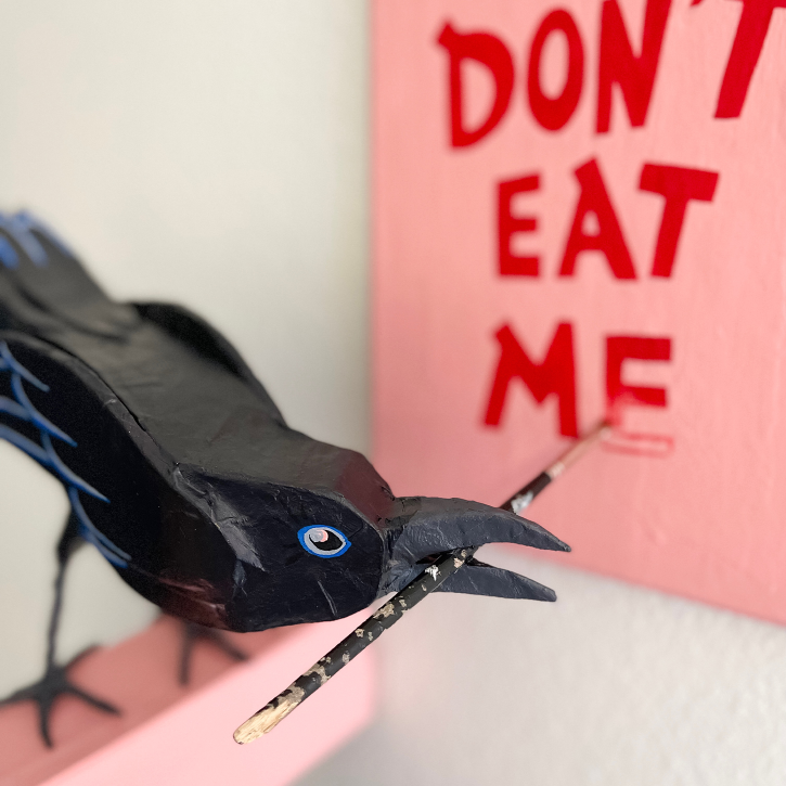 Paper Mache Crow Painting a Canvas That Says Don't Eat Me, Face Detail
