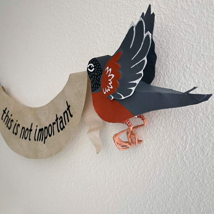 The Robins Are Judging You, Paper Mache Robins Holding This Is Not Important Banner, Detail